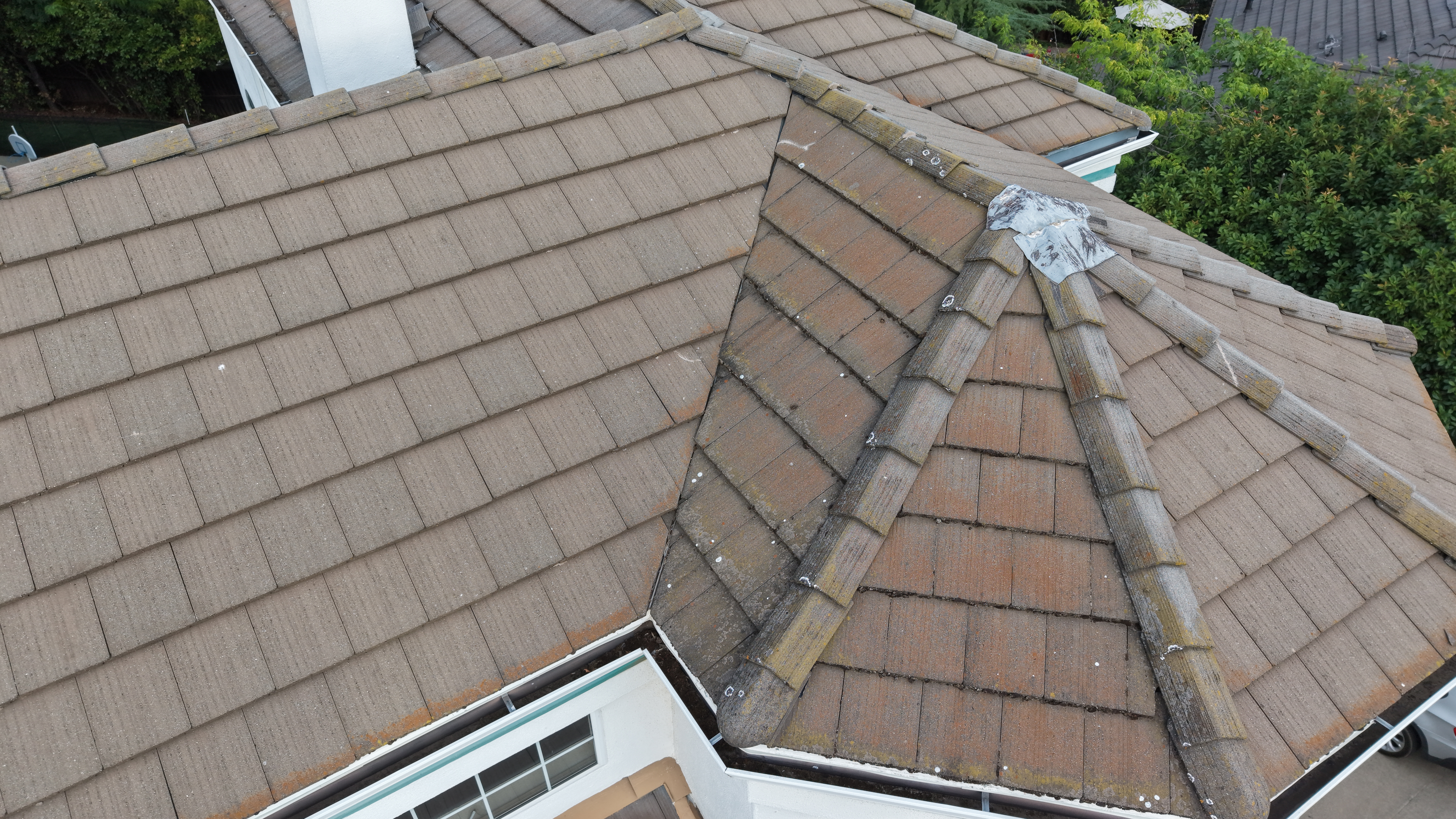 High-resolution aerial view of a residential roof with tile ridges and hip sections for inspection documentation